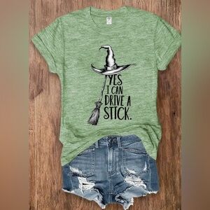 Black Witch Hat Humorous Graphic Tee “ YES I CAN DRIVE A STICK”